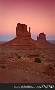 Sunset beautifully brings out the red rock of the mittens. Taken at Monument Valley near the Utah and Arizona border.. Commercial Photography