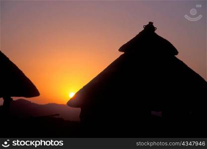 Sunset behind Konso Huts in Ethiopia
