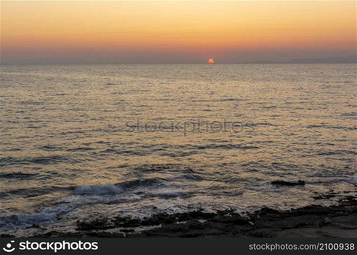 Sunset behind Kythera island. Natural beauty with Mediterranean colors in an idyllic Greek island. Beautiful sunset behind Kythera island. Natural beauty in an idyllic Greek island