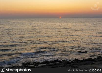 Sunset behind Kythera island. Natural beauty with Mediterranean colors in an idyllic Greek island. Beautiful sunset behind Kythera island. Natural beauty in an idyllic Greek island