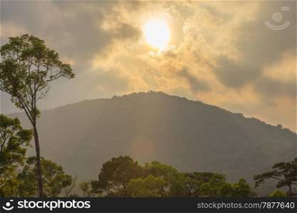 sunset behind mountains with Tropical rain forest