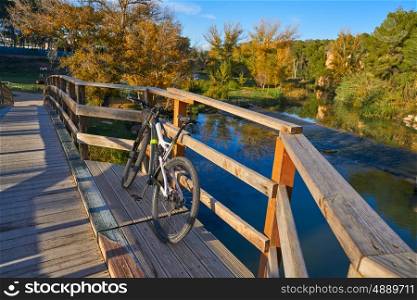 Sunset bike on autumn fall wood bridge at Parque de Turia of Valencia park in spain