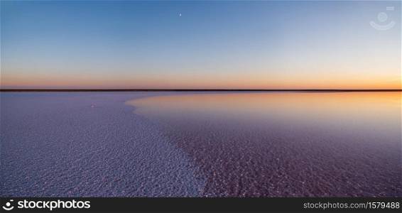 Sunset Genichesk pink extremely salty lake panorama (colored by microalgae with crystalline salt depositions), Ukraine.
