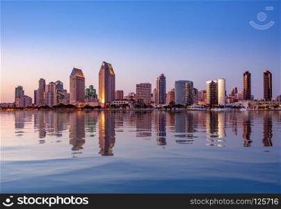 Sunset illuminating the tall skyscrapers of San Diego in California from Centennial Park in Coronado with artificial water reflection. San Diego Skyline at sunset from Coronado