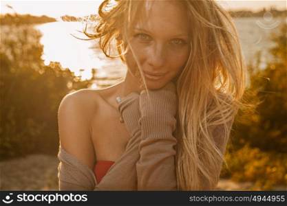 Sunset image of blonde girl backlit