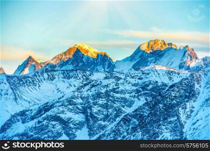 Sunset in mountains covered by snow.