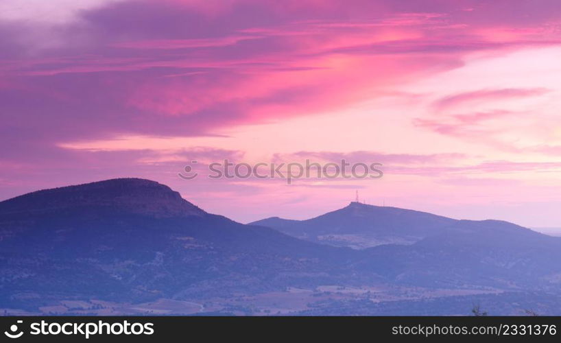 Sunset in mountains. Sun sinking below horizon. Nature landscape in province of Burgos, Castile and Leon community, northern Spain.. Sunset in mountains.