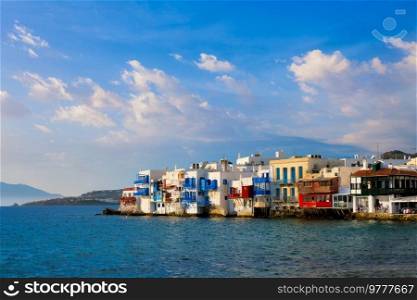 Sunset in Mykonos island, Greece with yachts in the harbor and colorful waterfront houses of Little Venice romantic spot . Mykonos townd, Greece. Sunset in Mykonos, Greece, with cruise ship and yachts in the harbor