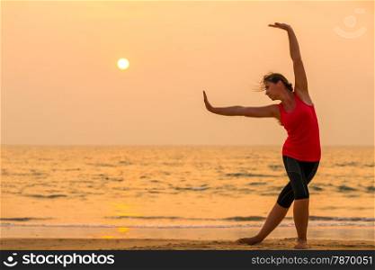 sunset in orange tones and woman yogas