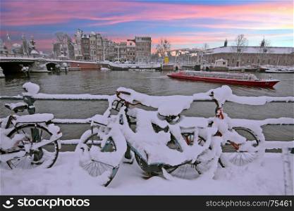 Sunset in snowy Amsterdam in the Netherlands at the Amstel in winter