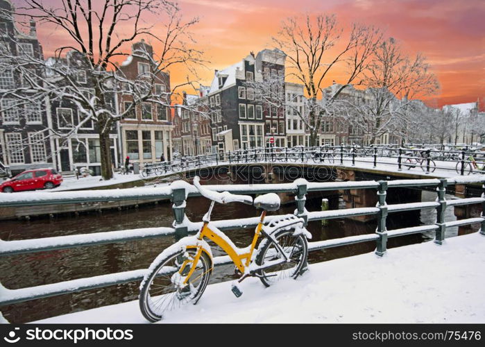 Sunset in snowy Amsterdam in the Netherlands at the Amstel in winter