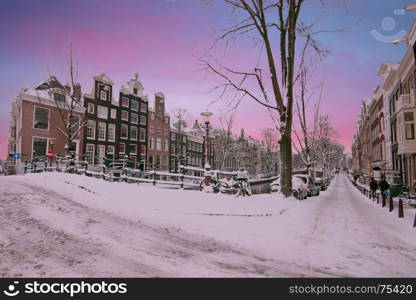 Sunset in snowy Amsterdam in the Netherlands in winter