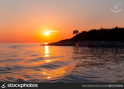 Sunset in the sea and a trace from the ship