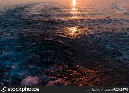 Sunset in the sea and a trace from the ship