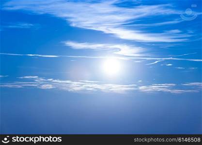 Sunset in the sky with blue clouds and big sun