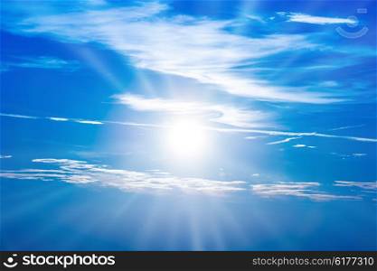 Sunset in the sky with blue clouds and big sun