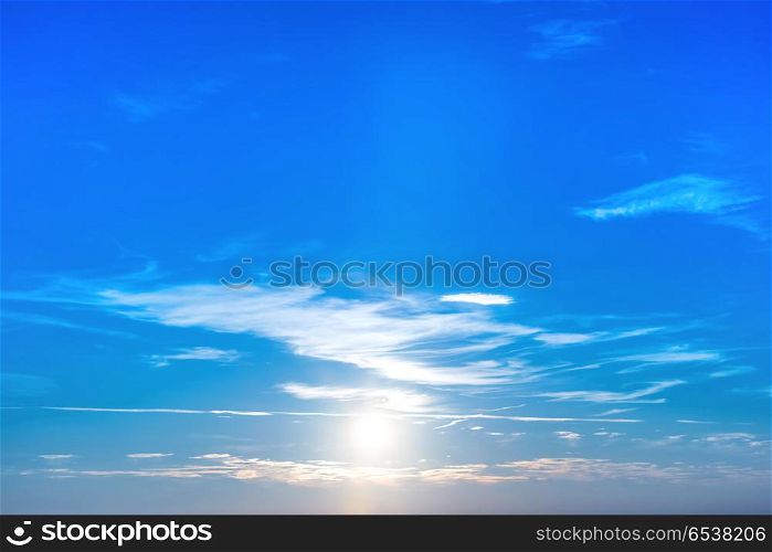 Sunset in the sky with blue clouds and big sun. Sunset in the sky with blue clouds