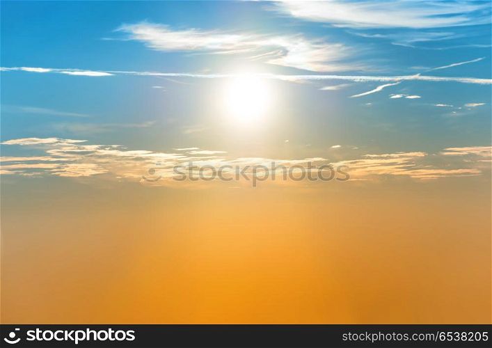 Sunset in the sky with blue orange clouds and big sun. Sunset in the sky with blue orange clouds