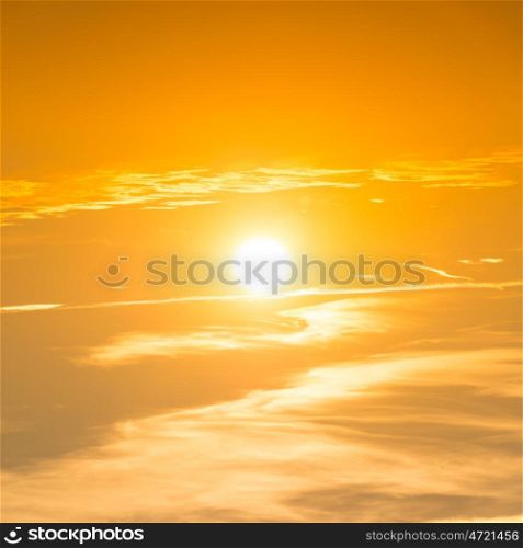 Sunset in the sky with orange clouds and big sun