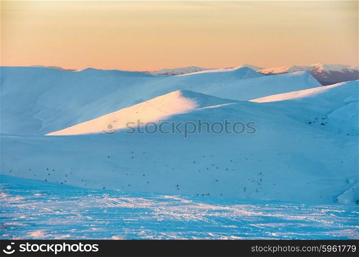 Sunset in winter mountains covered with snow.