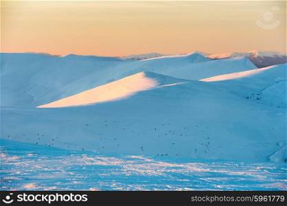 Sunset in winter mountains covered with snow.