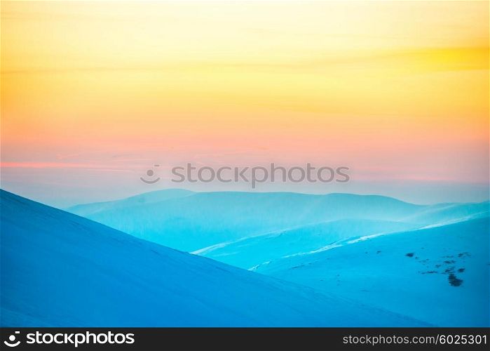 Sunset in winter mountains covered with snow
