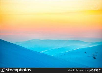 Sunset in winter mountains covered with snow