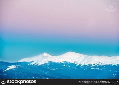 Sunset in winter mountains covered with snow. Ukraine, Hoverla and Petros