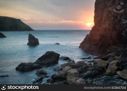 Sunset landscape seascape of rocky coastline at Hope Cove in England