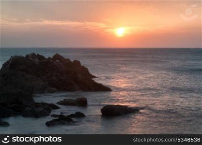 Sunset landscape seascape of rocky coastline at Hope Cove in England