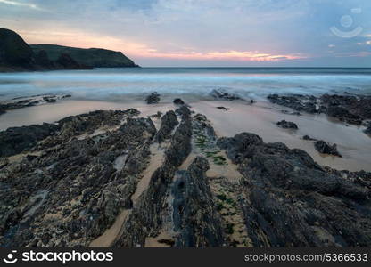 Sunset landscape seascape of rocky coastline at Hope Cove in England