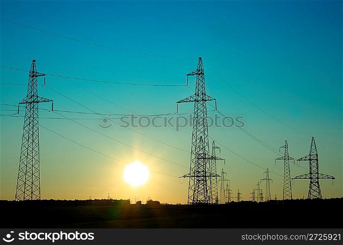 sunset landscape with electricity cable communication towers