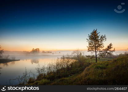 Sunset landscape with river shore, fog on the water and starry sky. Kirzhach river, Moscow Region, Russia