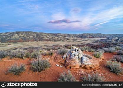 sunset light over foothills of Rocky Mountains in northern Colorado with red sandstone and canyons, aerial view