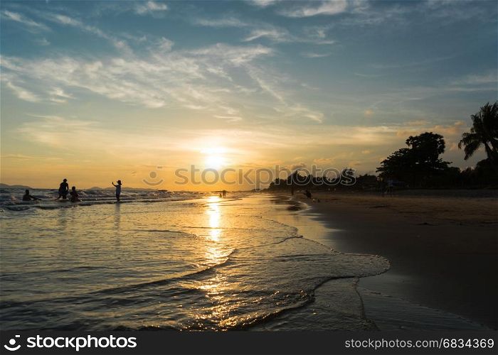 Sunset light shimmering water surface on tropical beach