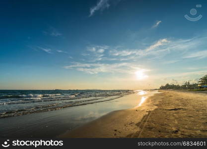 Sunset light shimmering water surface on tropical beach