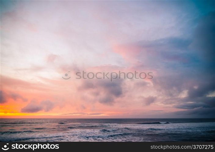 Sunset on a beach, beautiful sky and silky water.