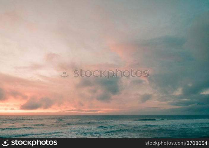 Sunset on a beach, beautiful sky and silky water.
