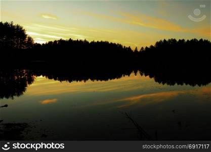 Sunset on a forest lake.