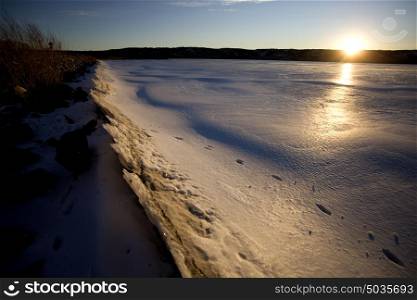 Sunset on Northern Lake in Winter Frozen Saskatchewan