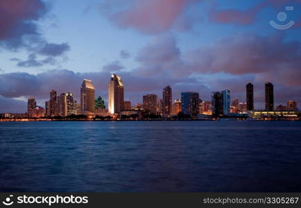 Sunset on San Diego skyline with city lights reflected in clouds taken from Coronado