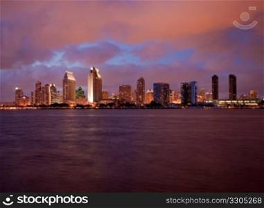 Sunset on San Diego skyline with city lights reflected in clouds taken from Coronado
