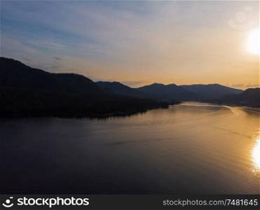 Sunset on Teletskoye lake in Altai mountains, Siberia, Russia. Drone shot.. Teletskoye lake in Altai mountains