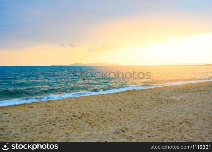 Sunset on the beach sea with cloud yellow sky background in the summer