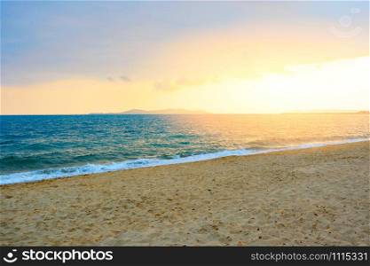 Sunset on the beach sea with cloud yellow sky background in the summer