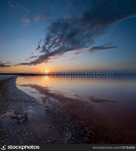 Sunset on the Genichesk pink extremely salty lake (colored by microalgae with crystalline salt depositions), Ukraine.