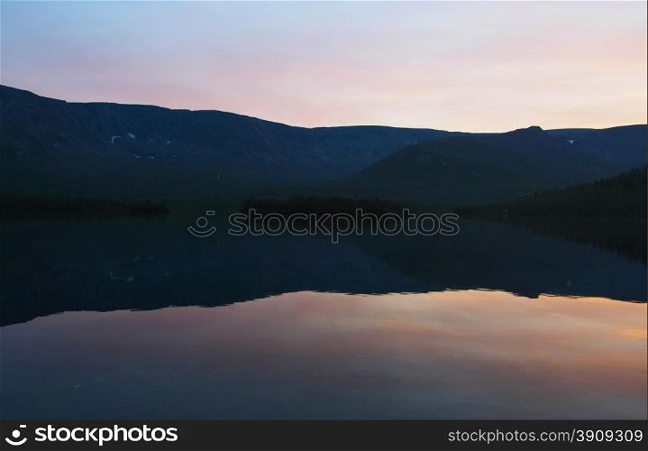 sunset on the lake in the mountains