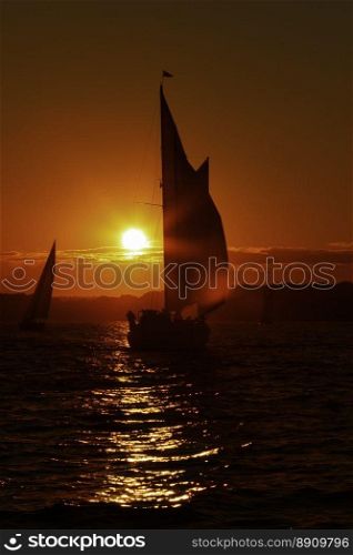 Sunset on the ocean.. Sail boat at sunset on the ocean.