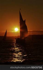 Sunset on the ocean.. Sail boat at sunset on the ocean.