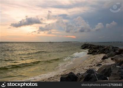 sunset on the rocky beach. destin, florida, usa